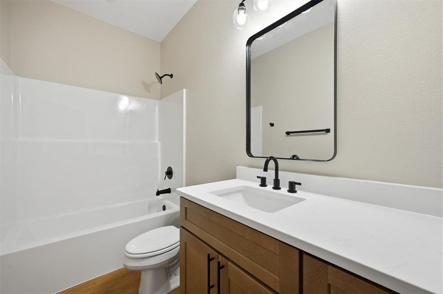 Full bath featuring vanity, shower / washtub combination, and light wood-type flooring Full bath featuring vanity, shower / washtub combination, and light wood-type flooring