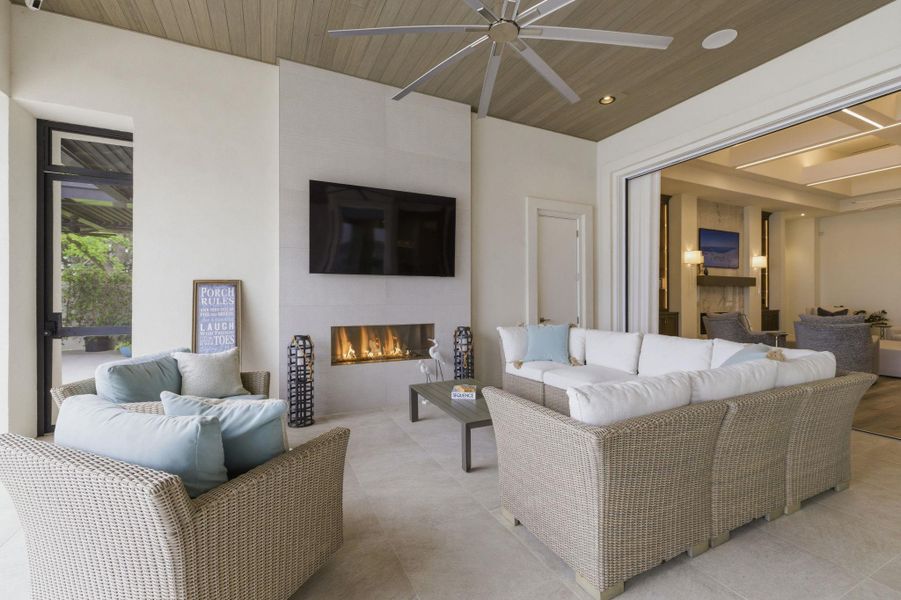 Tiled living area with a ceiling fan, a fireplace, wooden ceiling, and recessed lighting