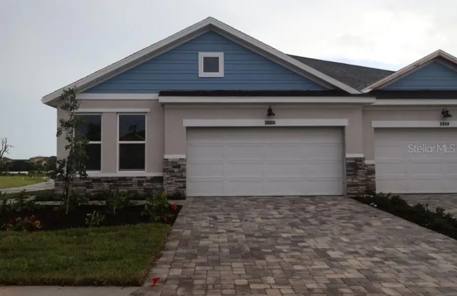 Front exterior of a new home in Gracewater at Sarasota, Sarasota, FL, highlighting curb appeal (Image 1). Front exterior of a new home in Gracewater at Sarasota, Sarasota, FL, highlighting curb appeal (Image 1).