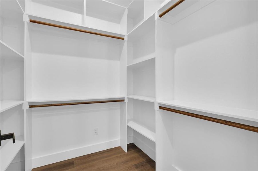 Spacious closet with dark wood-style floors Spacious closet with dark wood-style floors