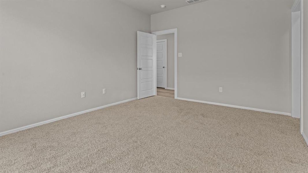 Carpeted empty room featuring baseboards Carpeted empty room featuring baseboards