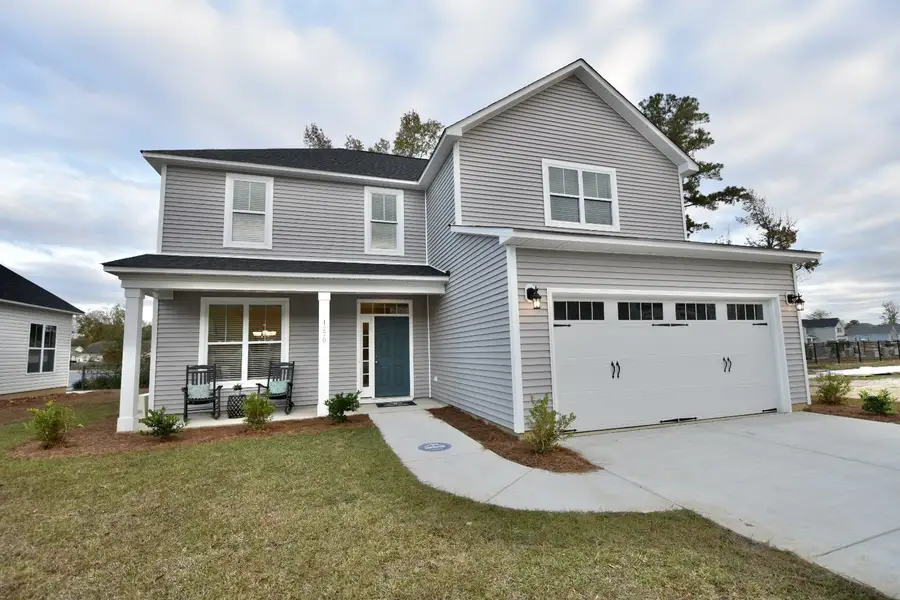 Front exterior of a new home in Patriot’s Watch, Shallotte, NC, highlighting curb appeal (Image 1). Front exterior of a new home in Patriot’s Watch, Shallotte, NC, highlighting curb appeal (Image 1).