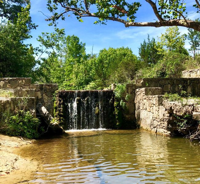 One of the dams on the property with a Waterfall when the creek is running and a natural grotto.
