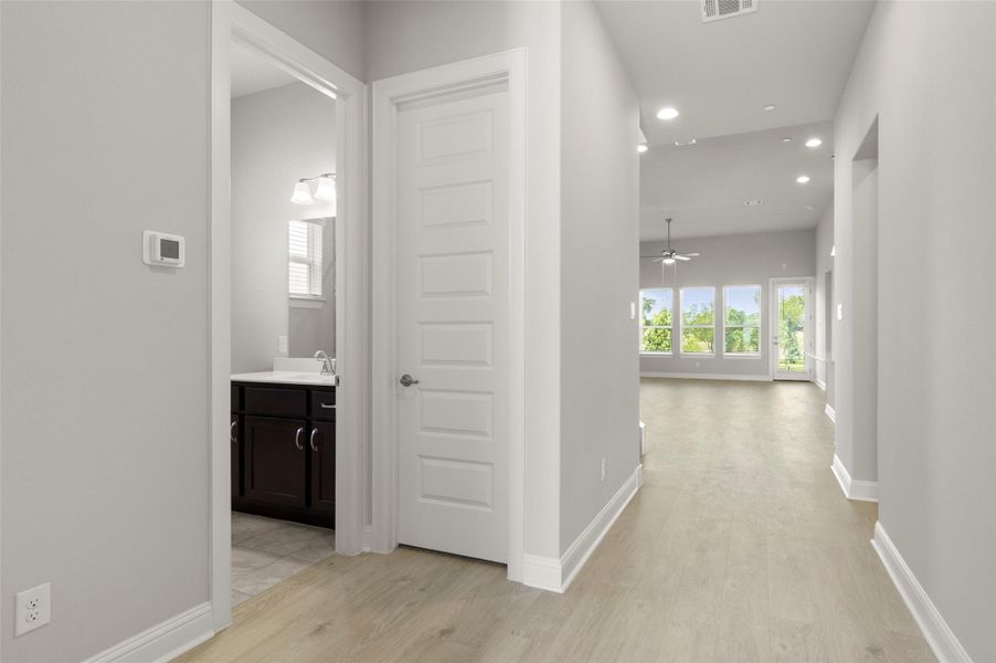 Hall with light wood finished floors and recessed lighting Hall with light wood finished floors and recessed lighting