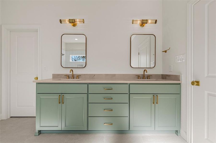 Full bathroom featuring double vanity and light tile patterned flooring Full bathroom featuring double vanity and light tile patterned flooring