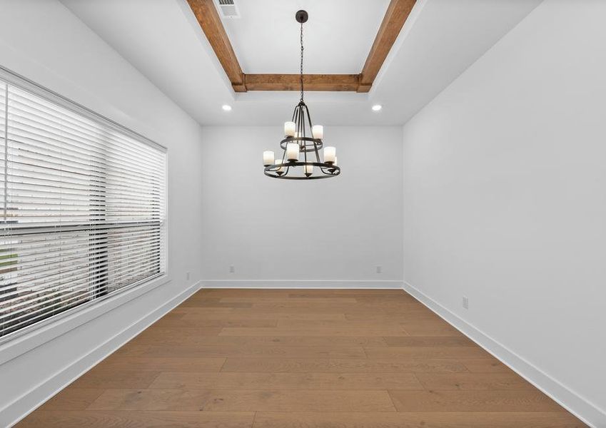 The formal dining room sits right off of the kitchen and has a large window.