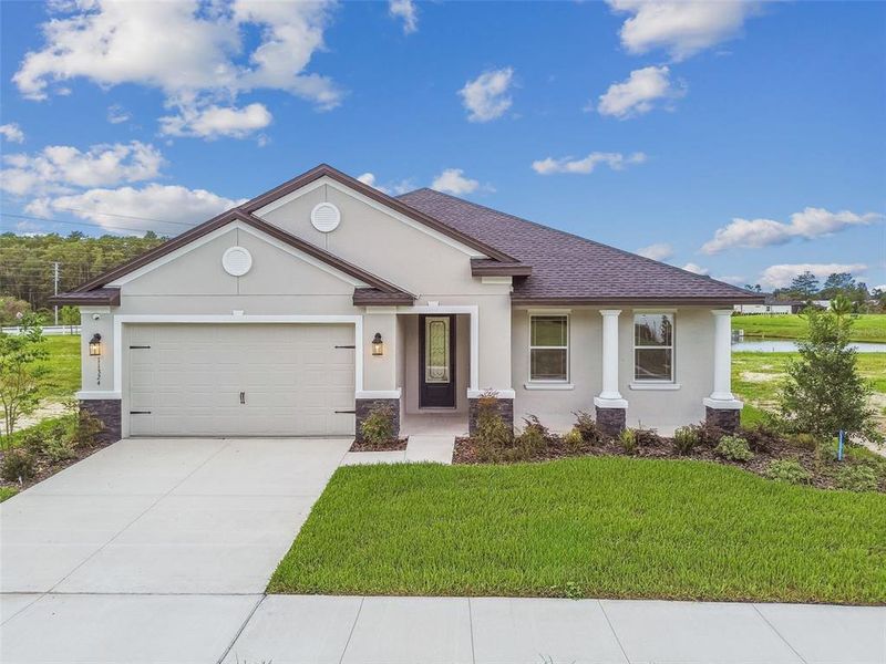 Front exterior of a new home in Hidden Ridge, New Port Richey, FL, highlighting curb appeal (Image 1). Front exterior of a new home in Hidden Ridge, New Port Richey, FL, highlighting curb appeal (Image 1).
