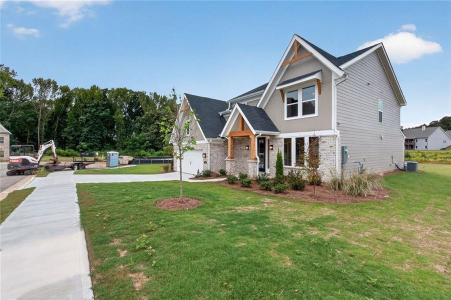 Front exterior of a new home in Hidden Fields, Hoschton, GA, highlighting curb appeal (Image 2). Front exterior of a new home in Hidden Fields, Hoschton, GA, highlighting curb appeal (Image 2).