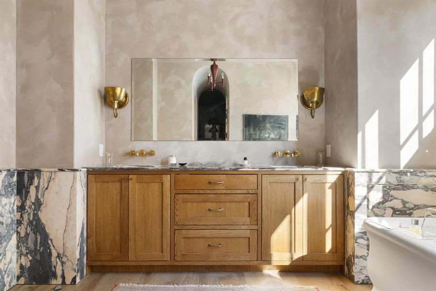 Bathroom featuring double vanity and light wood-style floors