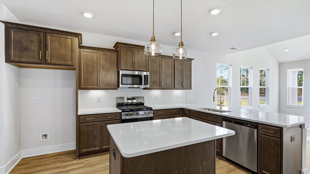 Vibrant kitchen layout with a center island, refined finishes, and open-concept flow in Fountain Inn, SC Vibrant kitchen layout with a center island, refined finishes, and open-concept flow in Fountain Inn, SC