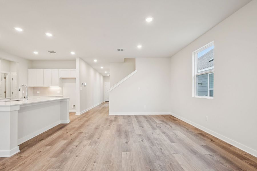 A kitchen with white cabinets.