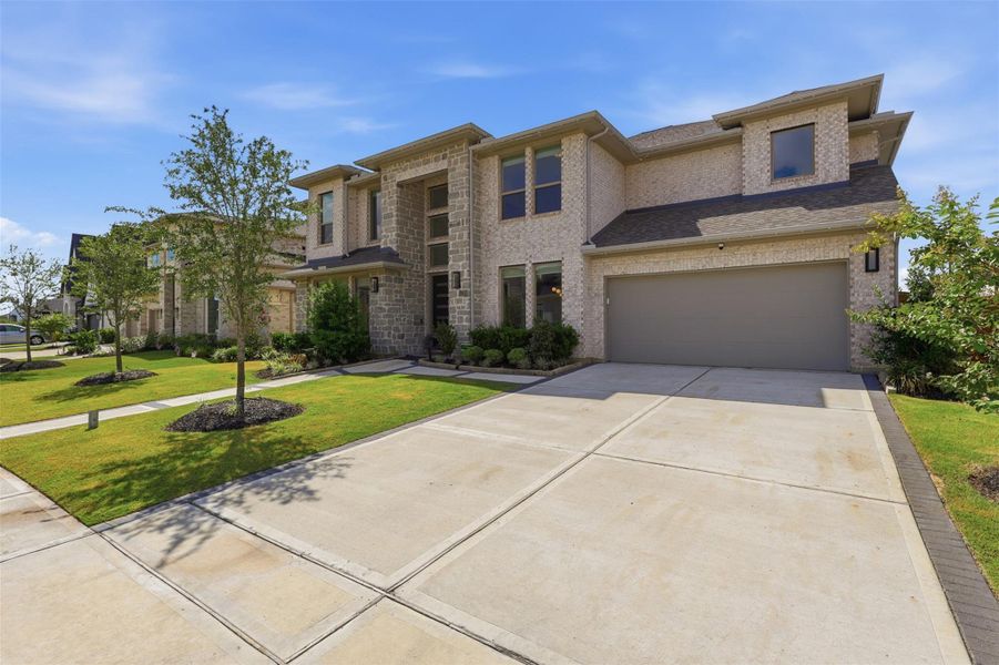 Front exterior of a new home in Elyson, Katy, TX, highlighting curb appeal (Image 2). Front exterior of a new home in Elyson, Katy, TX, highlighting curb appeal (Image 2).
