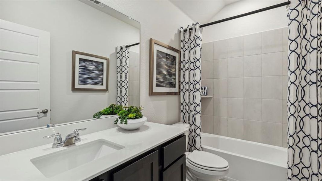 The bathroom features a vanity with a white countertop and an undermount sink