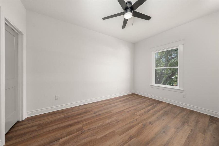 Spare room with wood finished floors and ceiling fan Spare room with wood finished floors and ceiling fan
