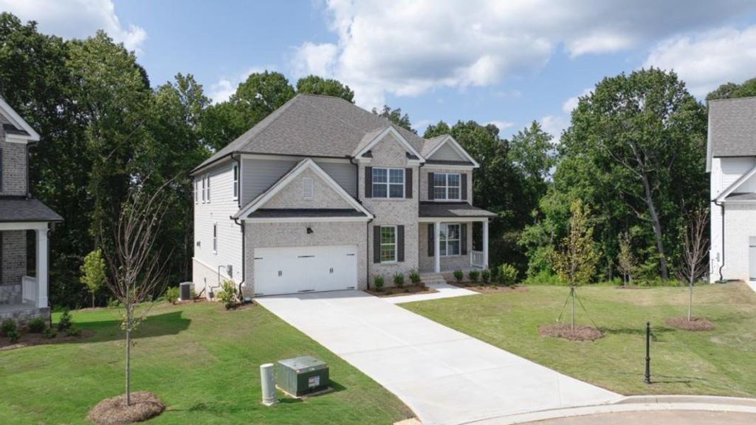Front exterior of a new home in Thalley Creek Estates, Cumming, GA, highlighting curb appeal (Image 2). Front exterior of a new home in Thalley Creek Estates, Cumming, GA, highlighting curb appeal (Image 2).