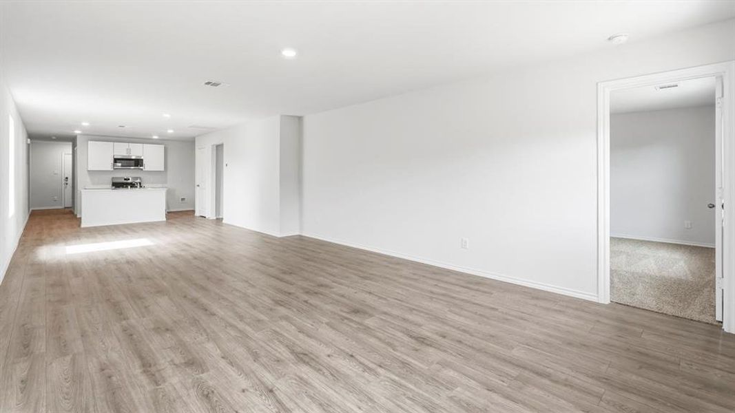 Unfurnished living room featuring recessed lighting and light wood-type flooring Unfurnished living room featuring recessed lighting and light wood-type flooring