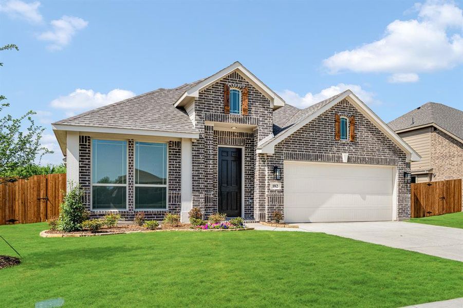 Front exterior of a new home in Sable Creek, Sanger, TX, highlighting curb appeal (Image 2). Front exterior of a new home in Sable Creek, Sanger, TX, highlighting curb appeal (Image 2).