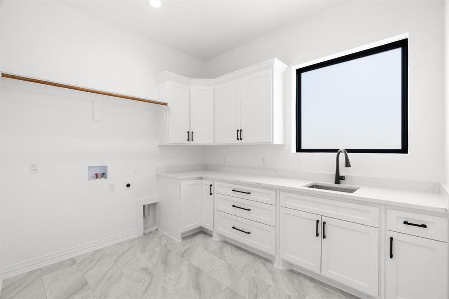 Washroom with hookup for a washing machine, hookup for an electric dryer, cabinet space, and recessed lighting Washroom with hookup for a washing machine, hookup for an electric dryer, cabinet space, and recessed lighting