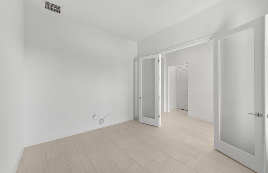 Enclosed flex room featuring elegant French doors