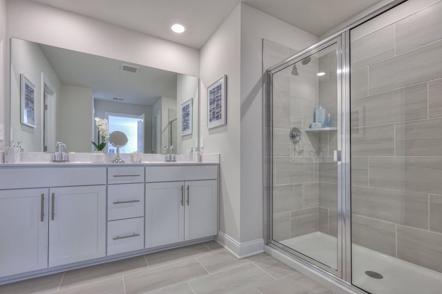 The primary bath offers dual vanity sinks and a walk-in closet.