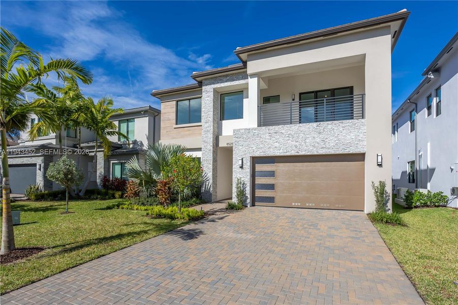 Front exterior of a new home in Lotus Edge, Boca Raton, FL, highlighting curb appeal (Image 24).