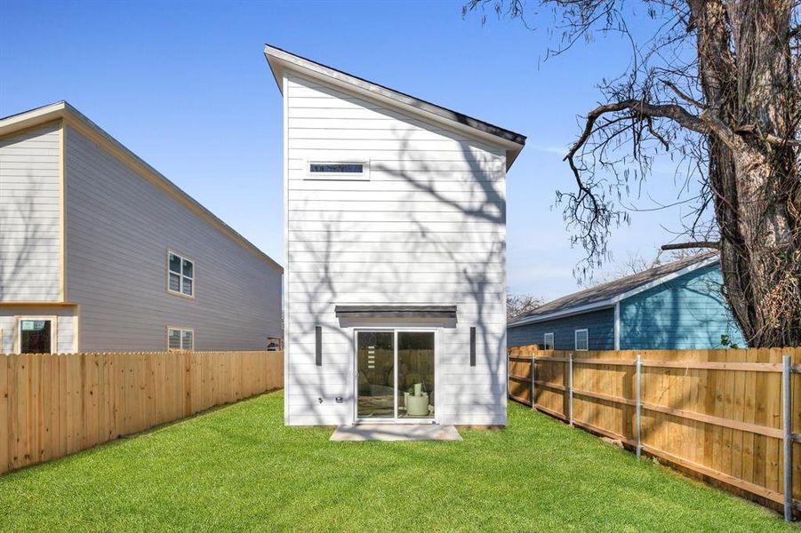 Rear view of house featuring a lawn