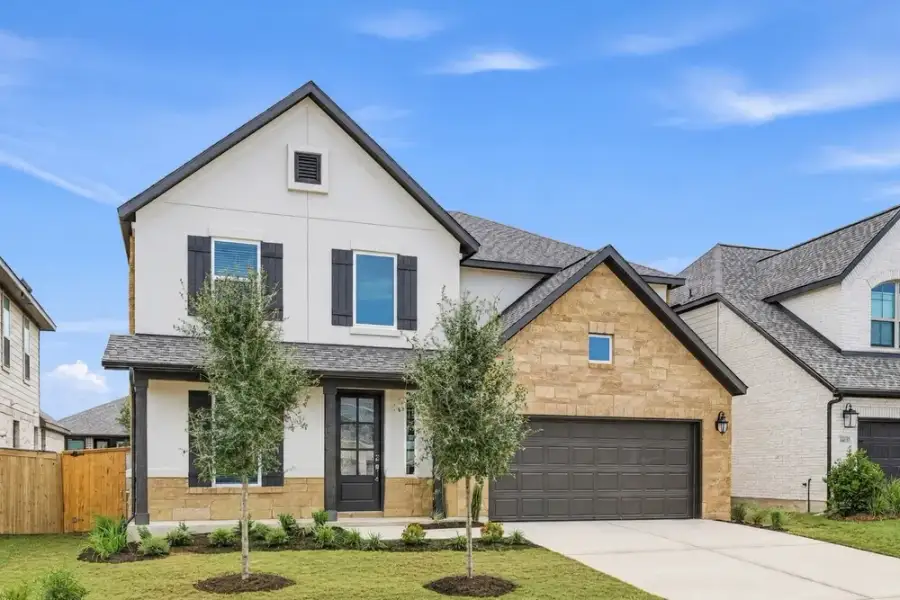 Front exterior of a new home in Parkside on the River, Georgetown, TX, highlighting curb appeal (Image 2). Front exterior of a new home in Parkside on the River, Georgetown, TX, highlighting curb appeal (Image 2).