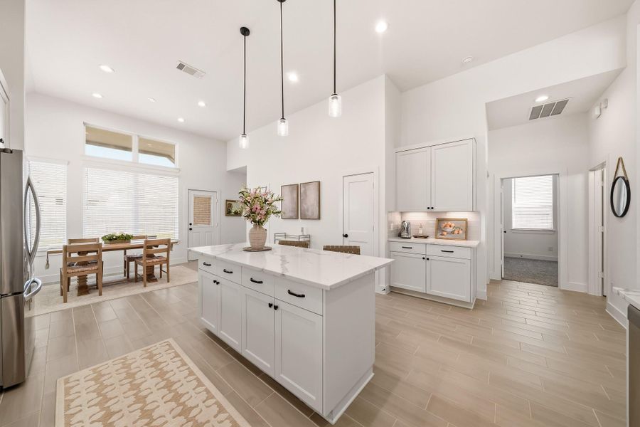 The beautifully designed kitchen island stands out with its generous proportions, ample cabinetry, expansive countertop space, and integrated seating, creating a polished focal point that balances everyday function with inviting style.