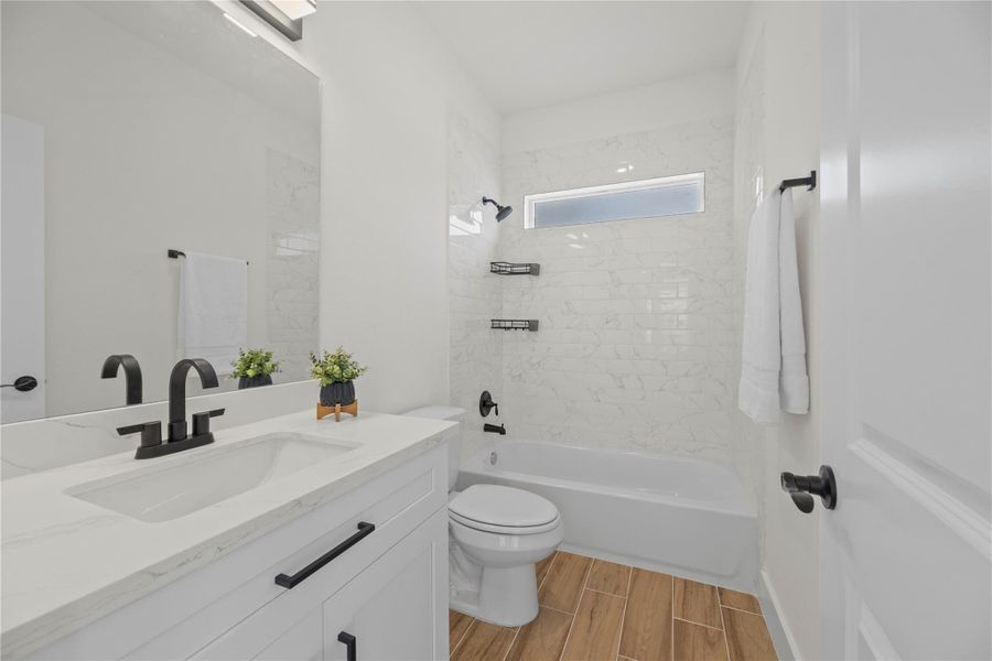 Intelligently sequestered, the full bathroom separates the shower/tub combo and toilet from the vanity area. Multiple individuals may indulge in vital self-care within the same space Intelligently sequestered, the full bathroom separates the shower/tub combo and toilet from the vanity area. Multiple individuals may indulge in vital self-care within the same space