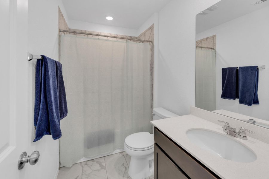 Full bath featuring vanity, marble finish floor, visible vents, and toilet