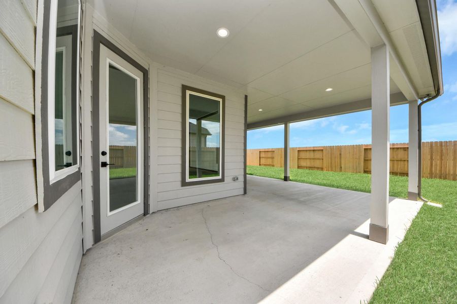 Experience outdoor living at its finest on this expansive covered patio, thoughtfully designed for BBQs and delightful outdoor dining. Sample photo of completed home with similar floor plan. Actual colors and selections may vary. Experience outdoor living at its finest on this expansive covered patio, thoughtfully designed for BBQs and delightful outdoor dining. Sample photo of completed home with similar floor plan. Actual colors and selections may vary.