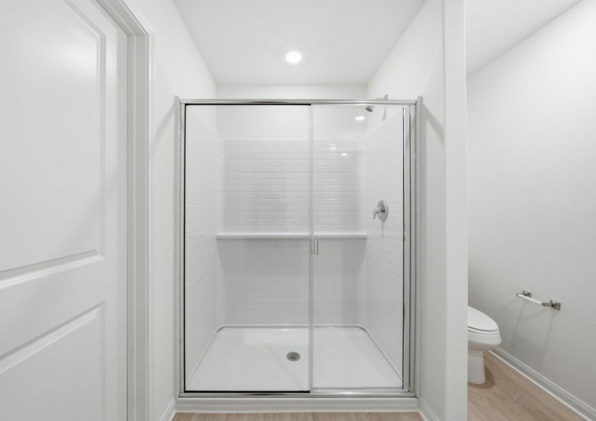 Primary bathroom featuring a glass-enclosed walk-in shower. Primary bathroom featuring a glass-enclosed walk-in shower.