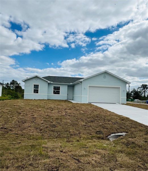 Front exterior of a new home in , Lehigh Acres, FL, highlighting curb appeal (Image 14).