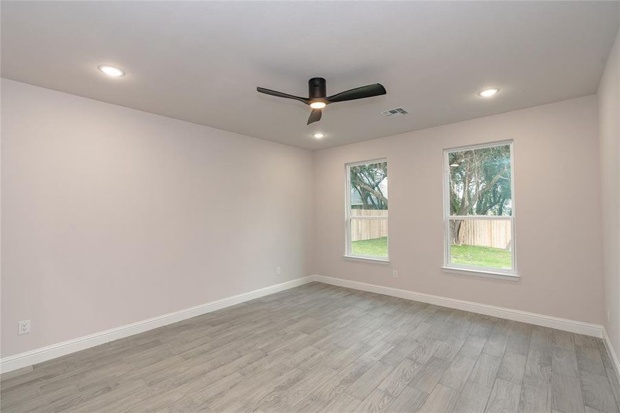 Spare room with light hardwood / wood-style flooring and ceiling fan