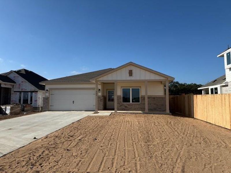 Ranch-style house with concrete driveway, brick siding, covered porch, board and batten siding, and a garage Ranch-style house with concrete driveway, brick siding, covered porch, board and batten siding, and a garage