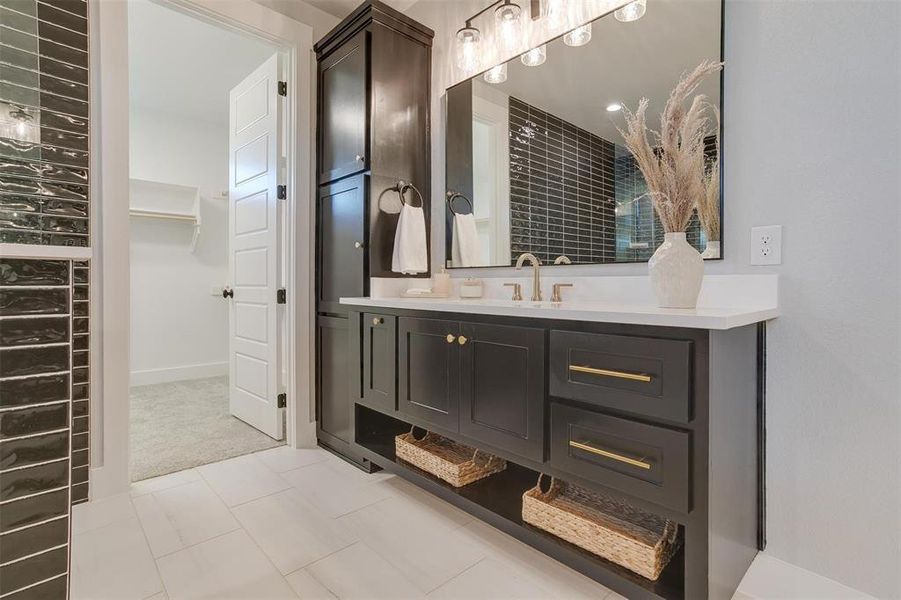 Bathroom featuring tile patterned flooring and vanity