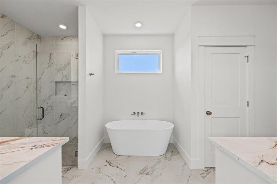 Freestanding soaking tub with wall-mounted fixtures