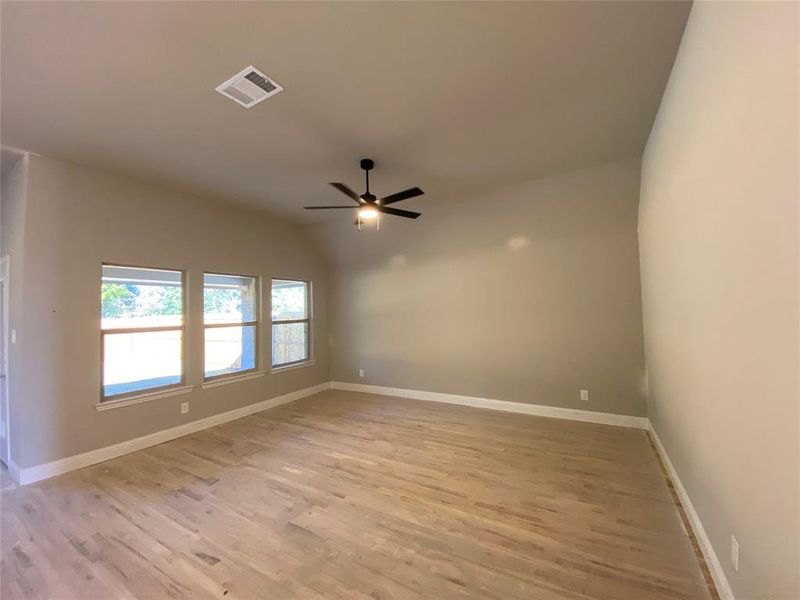 Family room with wall of windows and ceiling fan (hardwoods not stained Aged Barrel Grey w/Black tint yet) Family room with wall of windows and ceiling fan (hardwoods not stained Aged Barrel Grey w/Black tint yet)