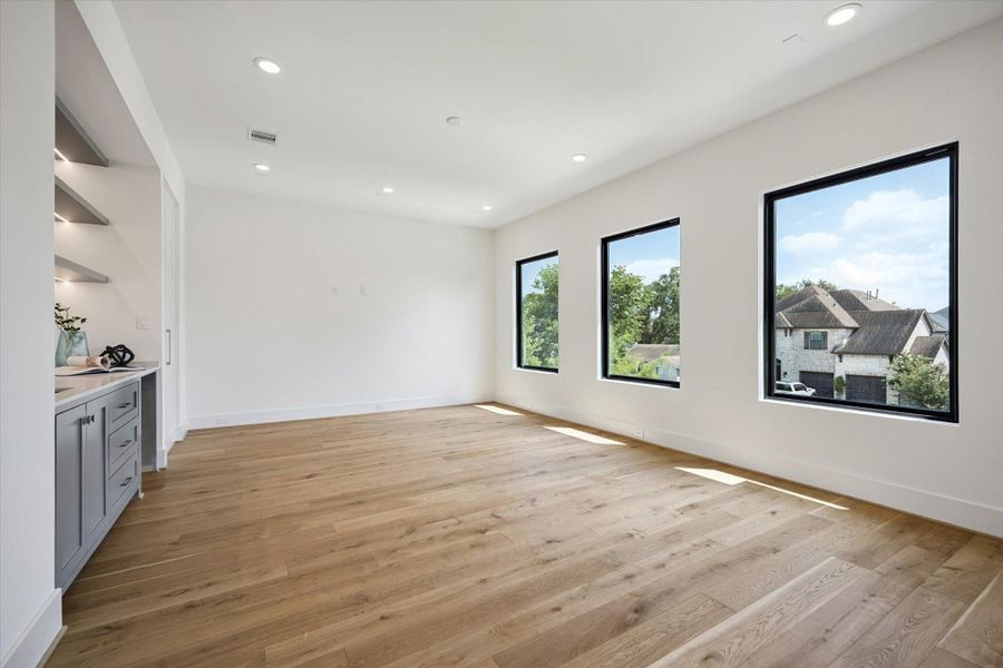 This gorgeous media/game room features a wet bar, storage spaces and a powder bathroom, making it the perfect spot for entertaining and fun nights! This gorgeous media/game room features a wet bar, storage spaces and a powder bathroom, making it the perfect spot for entertaining and fun nights!