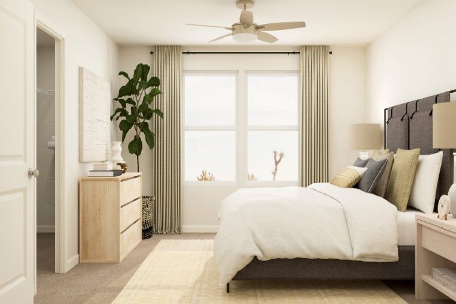 A bedroom with a bed and a fan.