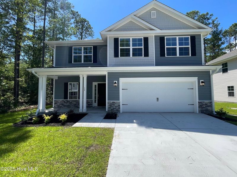 Front exterior of a new home in Mill Creek Cove, Bolivia, NC, highlighting curb appeal (Image 1).