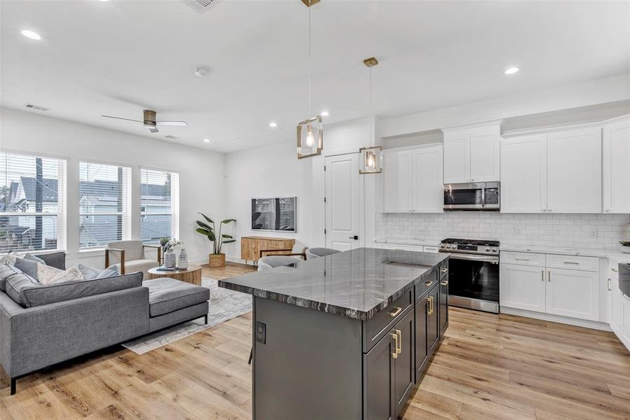 View from the kitchen, showcasing the central kitchen island and the open living area, creating a seamless flow cooking and entertaining.