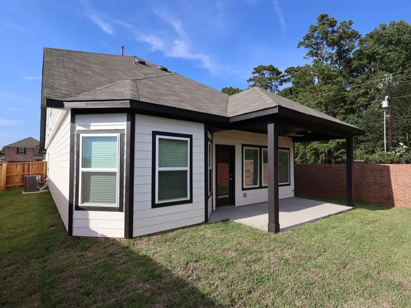 Front exterior of a new home in Lone Star Landing, Montgomery, TX, highlighting curb appeal (Image 1). Front exterior of a new home in Lone Star Landing, Montgomery, TX, highlighting curb appeal (Image 1).