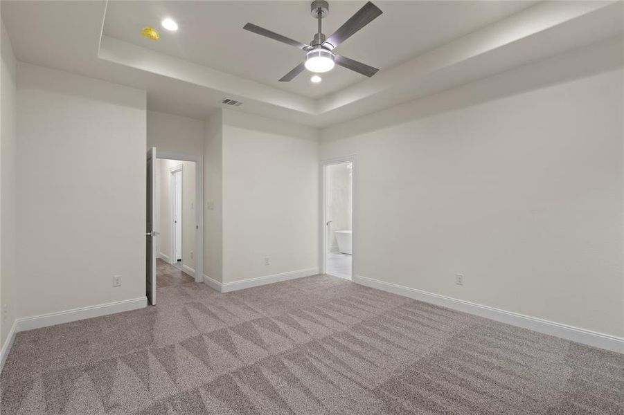 Recessed lighting, tray ceiling, and a contemporary ceiling fan with integrated lighting Recessed lighting, tray ceiling, and a contemporary ceiling fan with integrated lighting