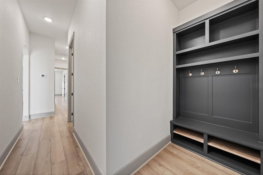 Mudroom with baseboards and light wood finished floors