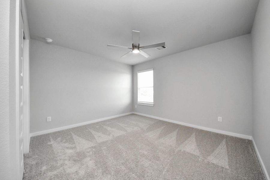 Generously sized secondary bedrooms featuring spacious closets, soft and inviting carpeting underfoot, large windows allowing plenty of natural light, and the added touch of privacy blinds for your personal retreat.