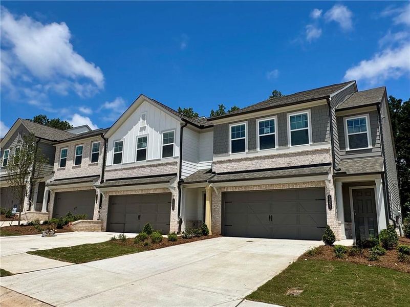 Front exterior of a new home in Eastlyn Crossing, Flowery Branch, GA, highlighting curb appeal (Image 13). Front exterior of a new home in Eastlyn Crossing, Flowery Branch, GA, highlighting curb appeal (Image 13).