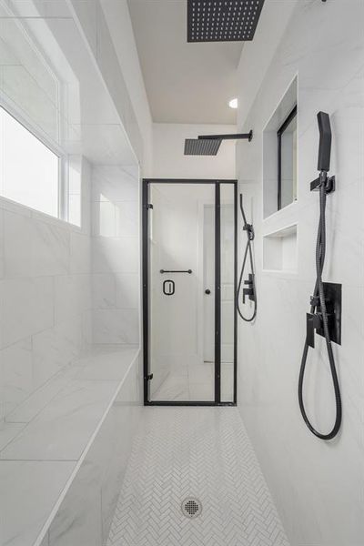 Bathroom with tiled shower and tile patterned flooring