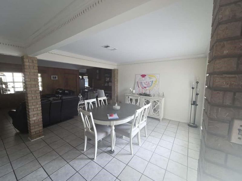 Dining room with ornamental molding, light tile patterned floors, and decorative columns Dining room with ornamental molding, light tile patterned floors, and decorative columns