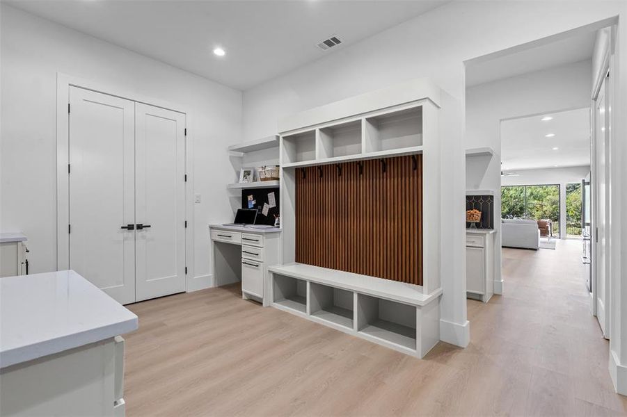 Mudroom with recessed lighting, light wood-style flooring, and built in study area